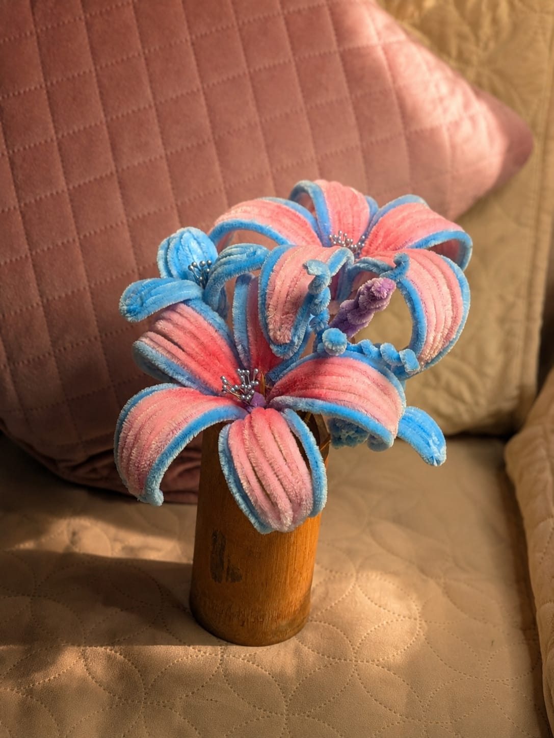 Blue and pink handmade pipe cleaner flower bouquet arranged in a wooden vase